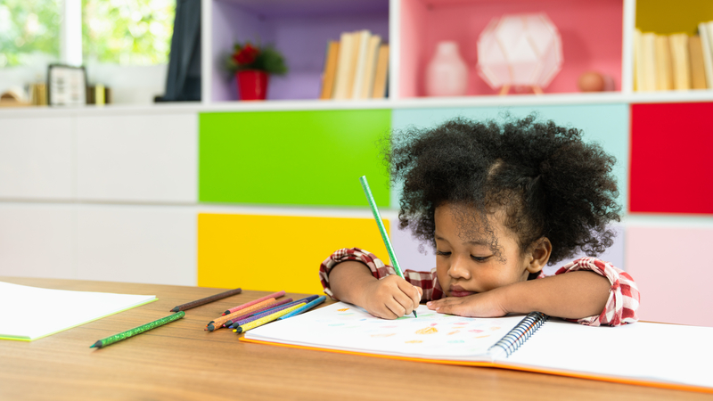 Young children drawing at home.
