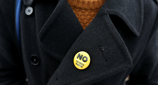 A photograph of a person wearing a jacket with a badge containing the words ‘No to Hull Tigers’.