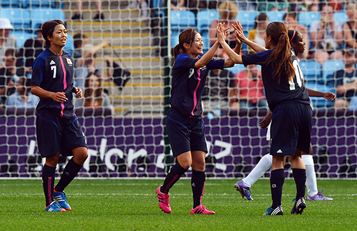 A photograph of three players celebrating.