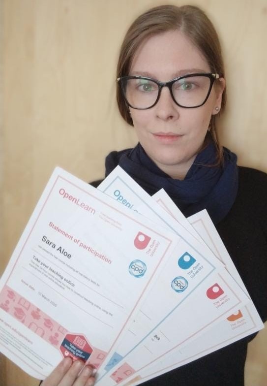 A photo of OpenLearn learner Sara Kay Aloe proudly holding up some of her OpenLearn certificates