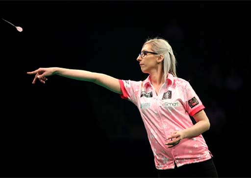 The image shows Fallon Sherrock, a darts player, throwing a dart.