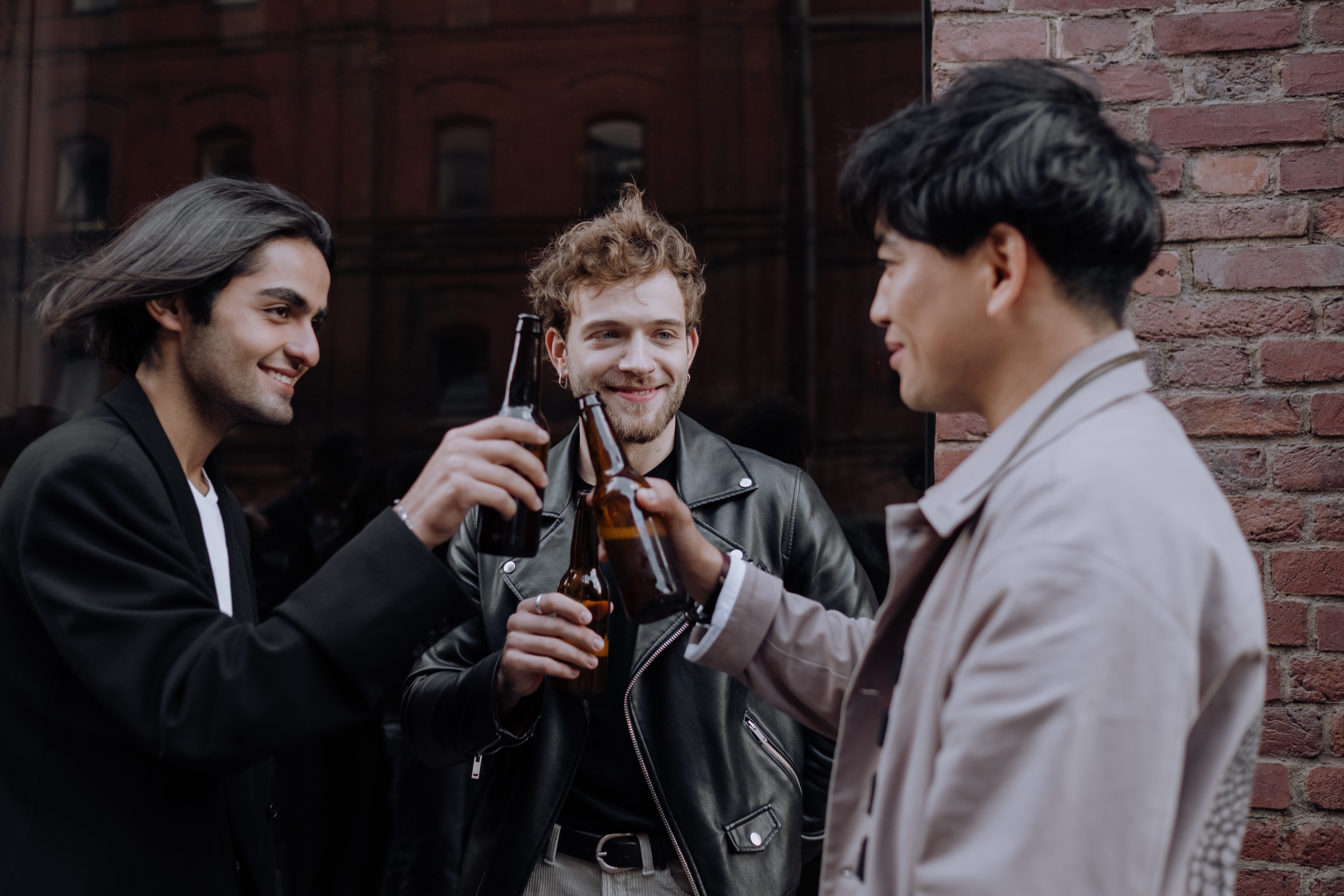 Three young men drinking beer