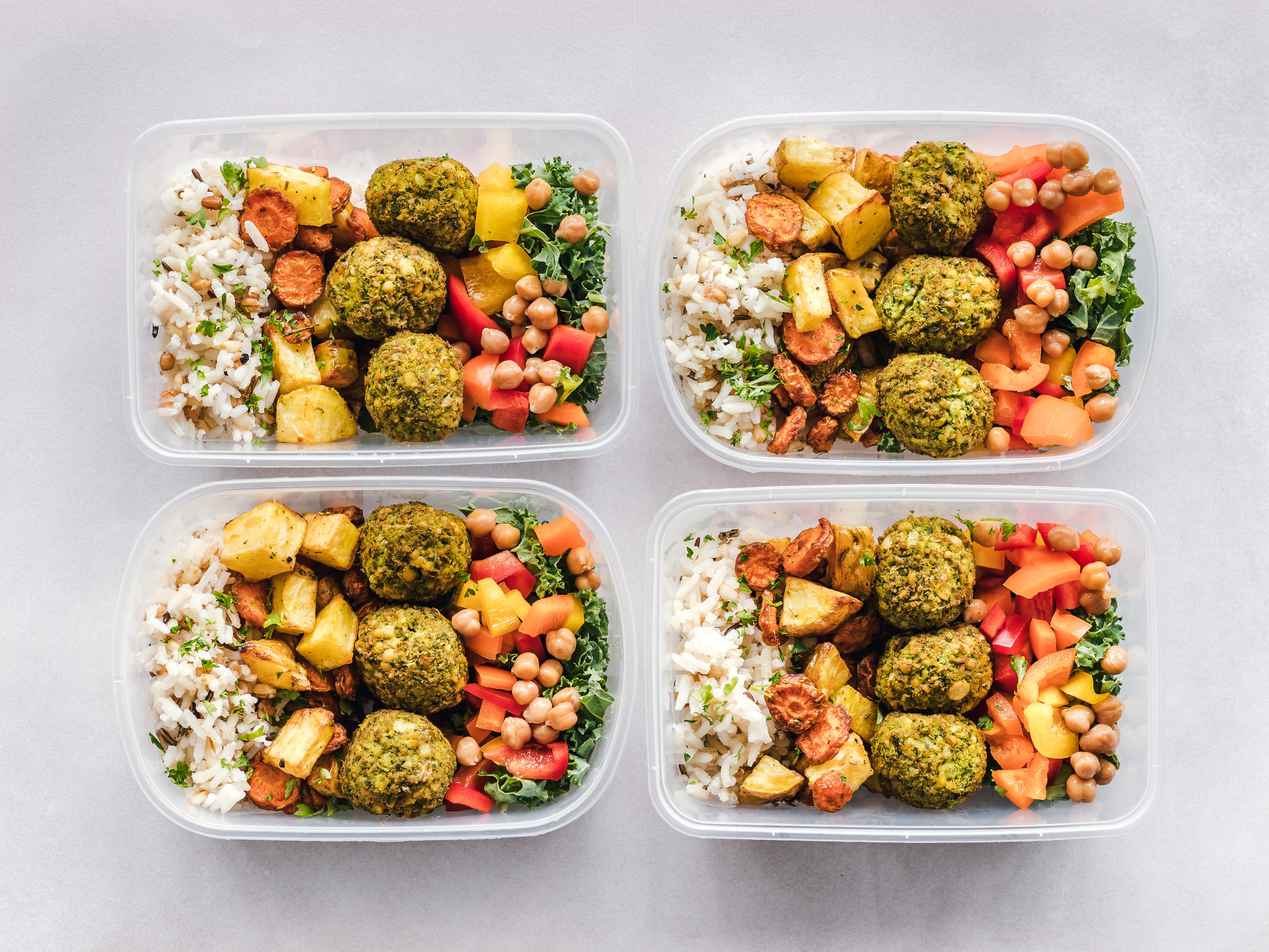Four lunchboxes with healthy food