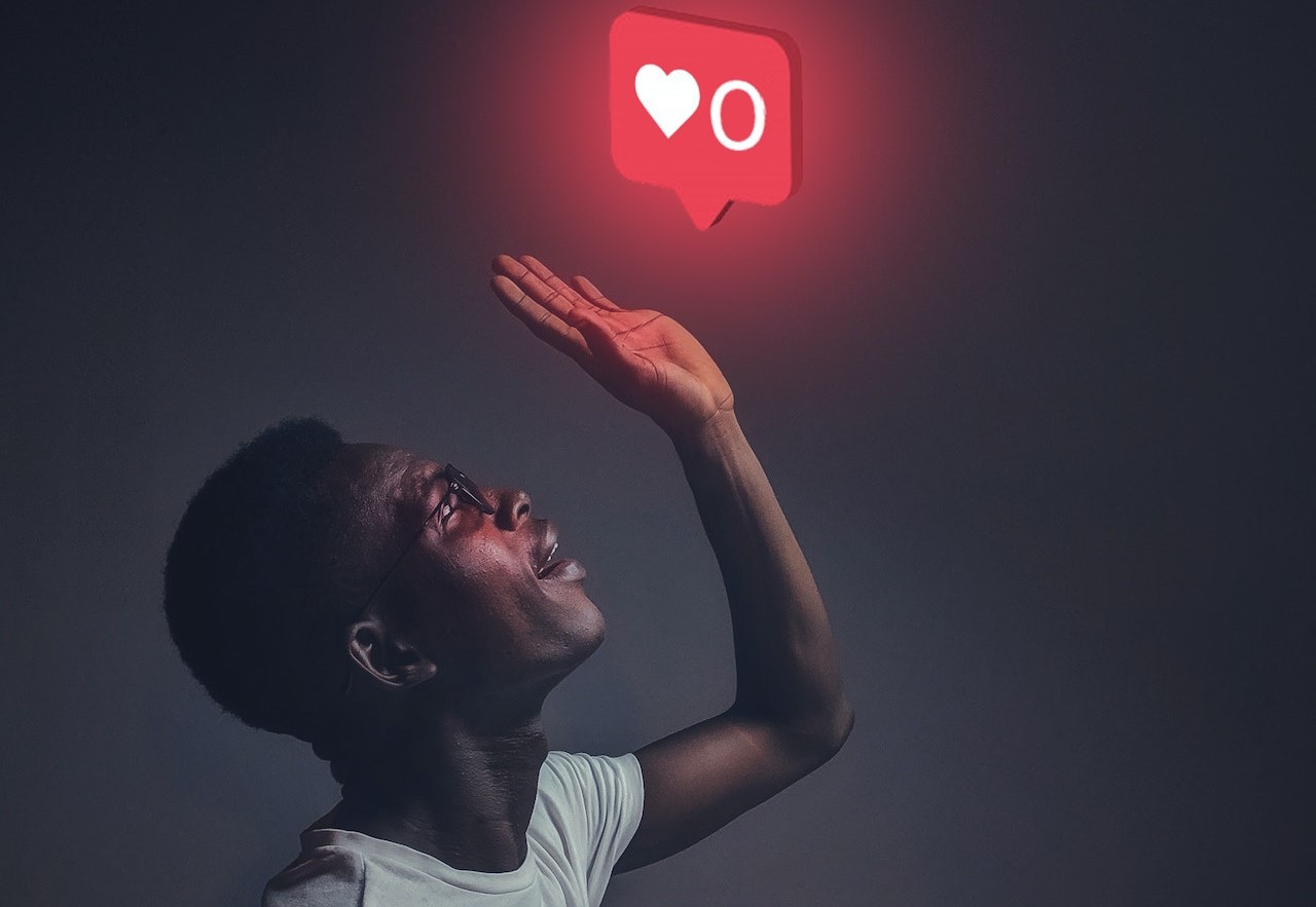 Instagram like button hovering above a young man