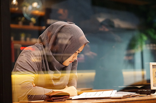 A photograph of a person at a desk studying.