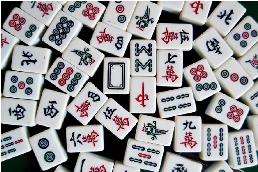 A photograph of several white tiles decorated with black and red symbols.