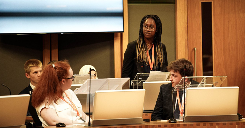 Angel Ezeadum speaking in the Welsh Youth Parliament.