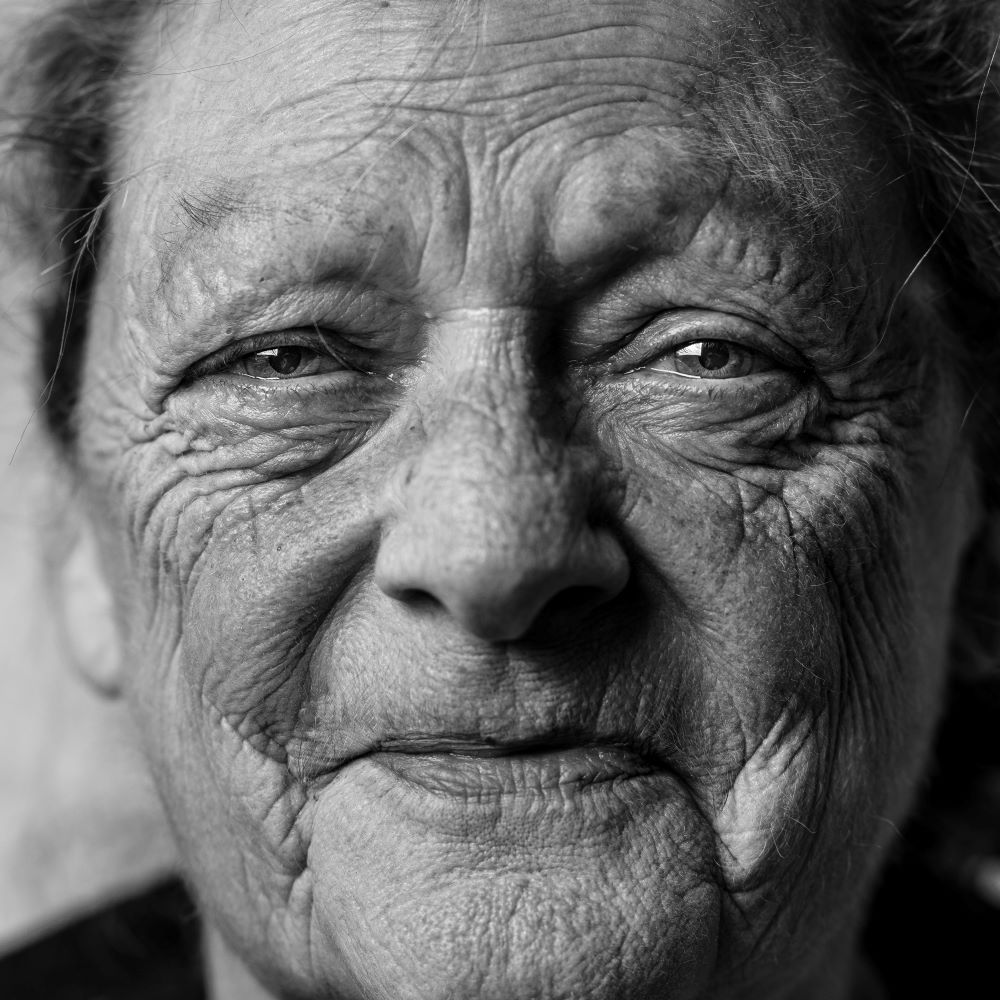 A very elderly lady, full face shot showing lots of wrinkles