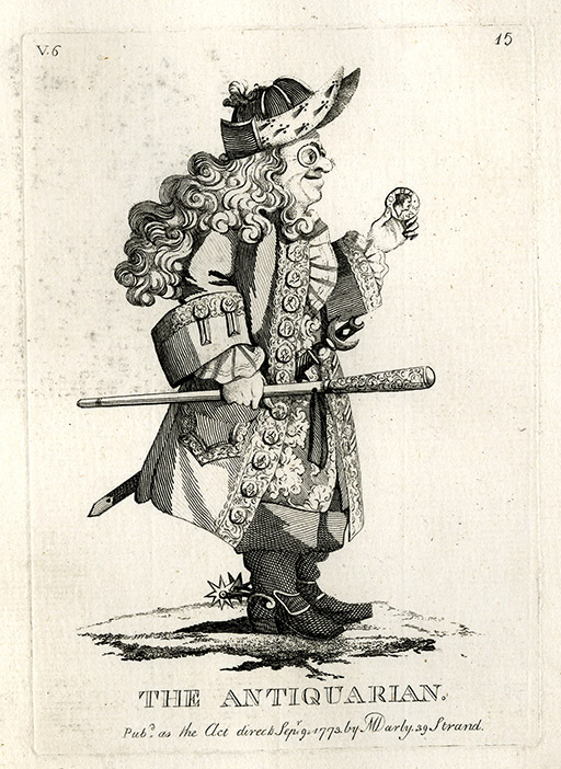 This is a black and white cartoon drawing of a man. He has long, curled hair and wears spectacles. He wears a long coat with turned up cuffs, a frilled shirt, and boots with spurs. The man smiles, staring at a coin in his hand. In his other hand is an ornate cane and he wears a sword. The ‘buttons’ on his coat are also coins and his hat has two peaks rising at the front. A small patch of earth is sketched below the man’s feet. There is no other background. At the bottom of the image are the words: ‘The Antiquarian’ printed in block text. Below this are the words: ‘Pub[lishe]d as the Act directs Sep 9 1773 by M Darly 39 Strand.’