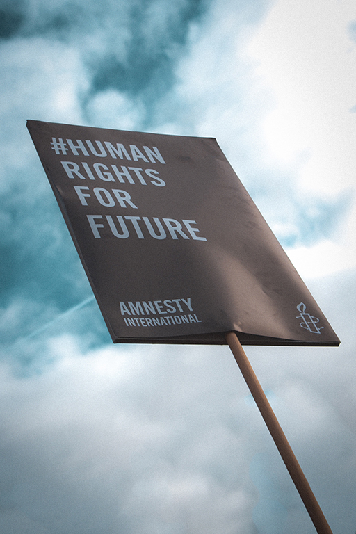 A photograph of a poster which reads: #Human rights for future. Amnesty International.