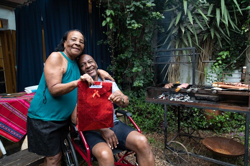 An image of two people outside at a BBQ.