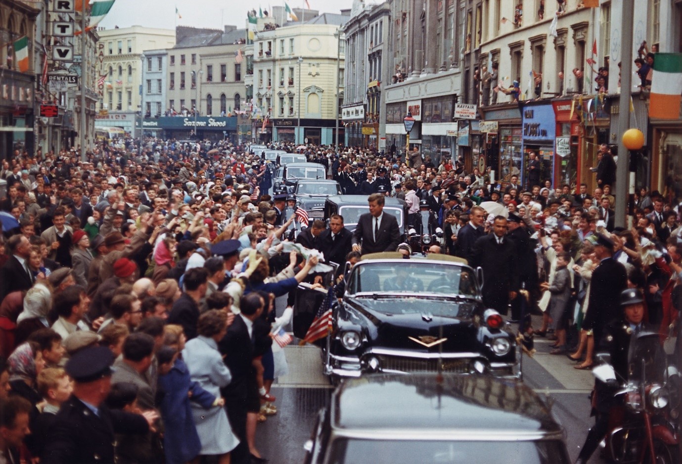 This photograph depicts President Kennedy’s motorcade in Patrick Street in Cork city on the 28th June 1963. 