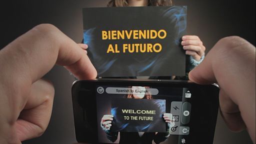 A hand holding a phone with the word lens app open, translating the words written on a board being help up on front. 