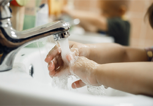 A photograph of a child washing their hands
