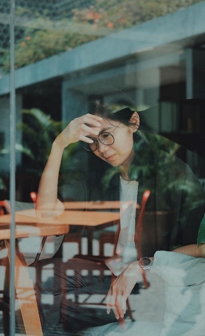 A person with their head in their hands.