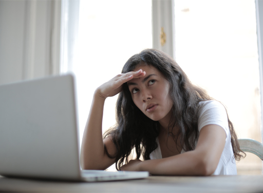 A person sitting in front of a laptop.