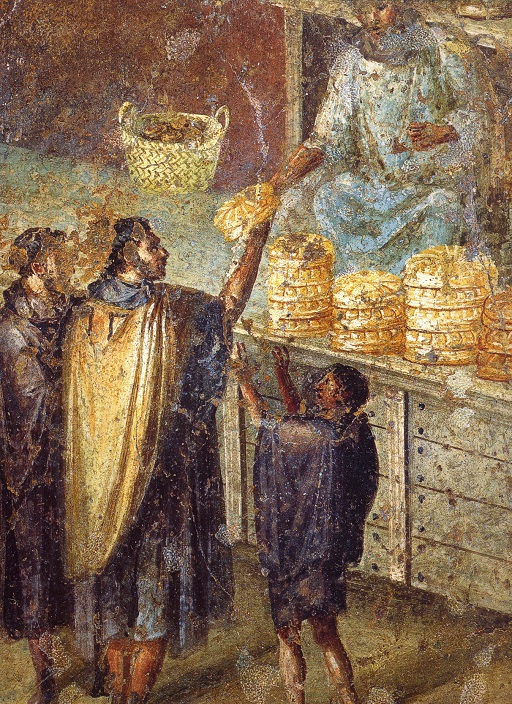 This image shows part of a wall painting. In it, a man in white robes (a tunic and toga) sits on some kind of stage or dais surrounded by piles of bread. He is handing one loaf of bread to a group of people stand-ing below him on the ground: two men and a boy wearing dark brown/purple tunics. The man in the middle also wears a yellow hooded cape.