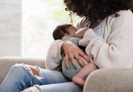 A photograph of a baby being breastfed
