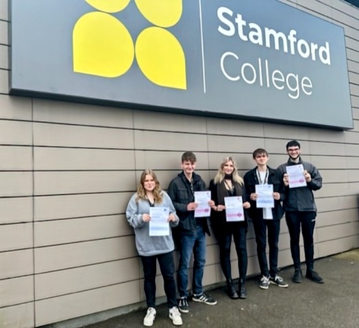 Students at Stamford College with their certificates of participation.