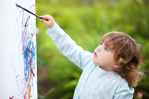A child painting outside