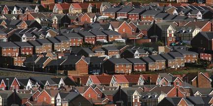 A photo of rows of red brick houses in a housing estate