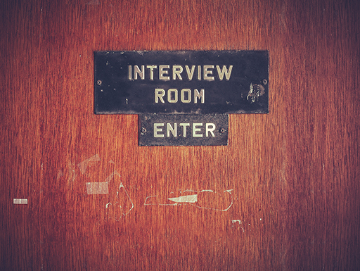 A photograph of a door with ‘Interview Room. Enter’ on it.