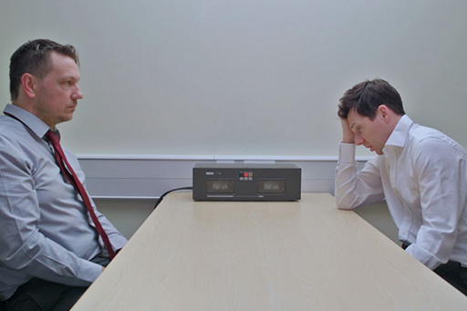 A photograph of DI Bullet interviewing Neale Anderson.