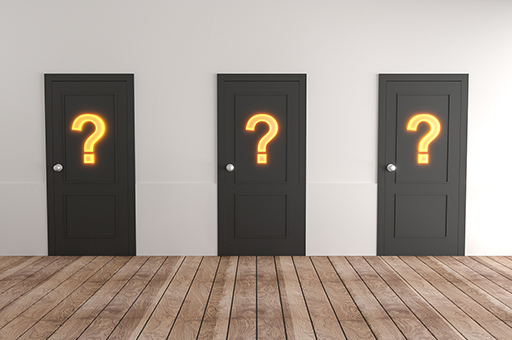 A photograph of three doors, each with a question mark on it.