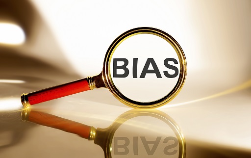 Picture of a magnifying glass over the word ‘bias’.