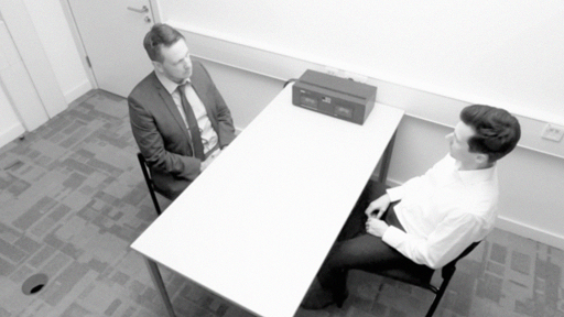 A photograph of DI Bullet interviewing Neale Anderson.