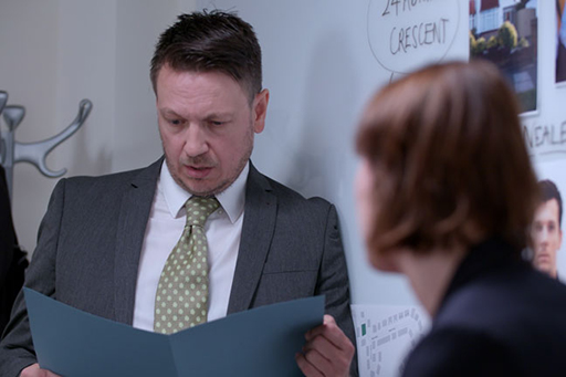 A photograph of DI Bullet and DS Sund in conversation.