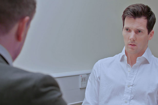 A photograph of DI Bullet interviewing Neale Anderson.