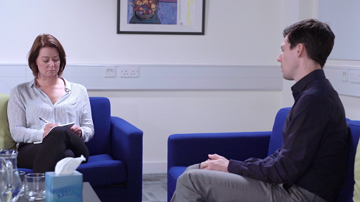 A photograph of DS Sund interviewing Neale Anderson.