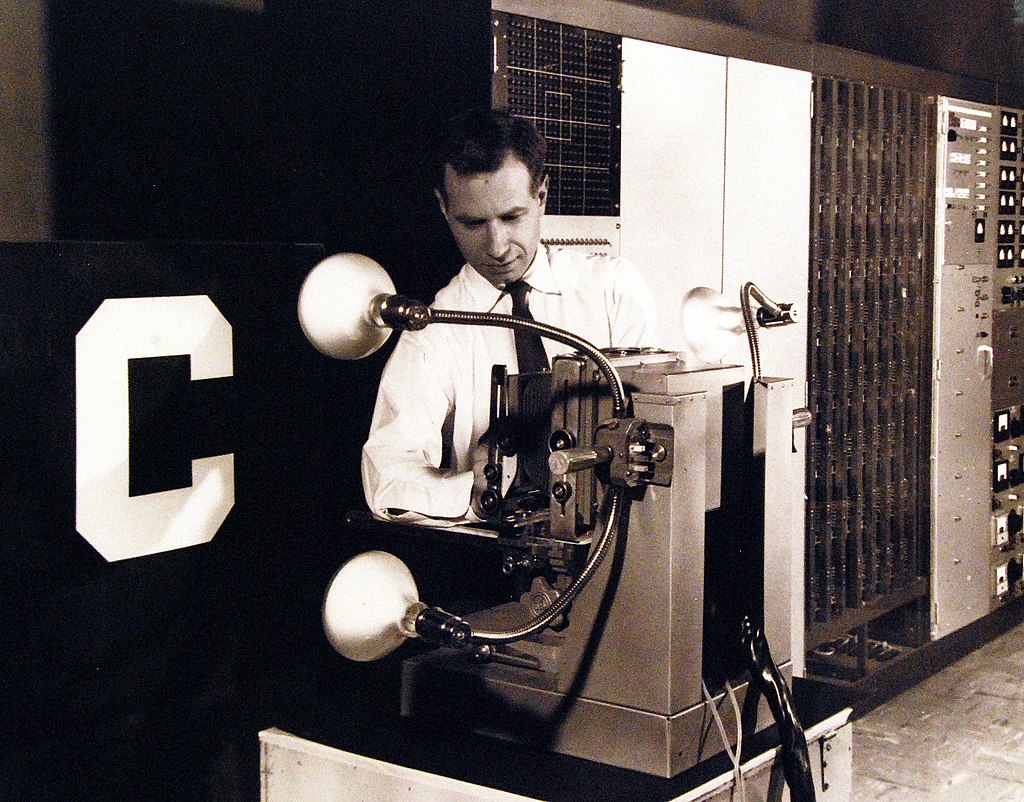The Mark 1 Perceptron, an artificial intelligence machine, being adjusted by Charles Wightman