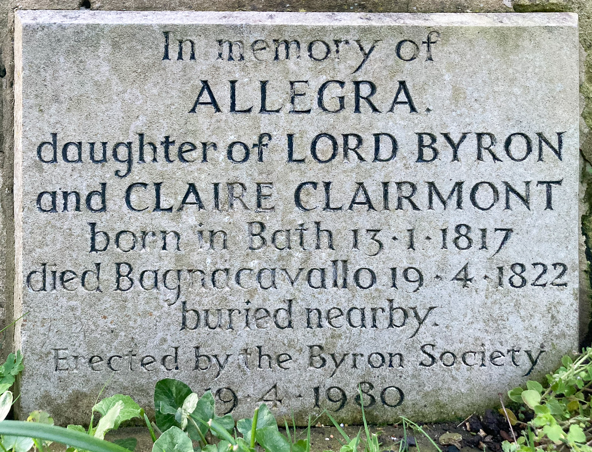 A stone memorial plaque for Allegra, daughter of Lord Byron and Claire Clairmont. It bears her birth and death dates: 13.1.18