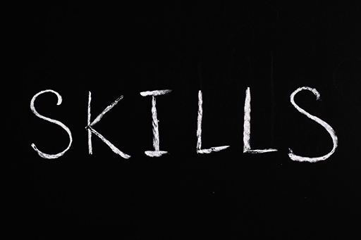 A graphic showing the word ‘Skills’ written on a black background.