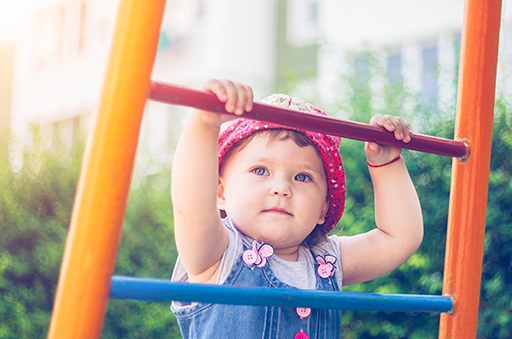 A baby on a climbing frame