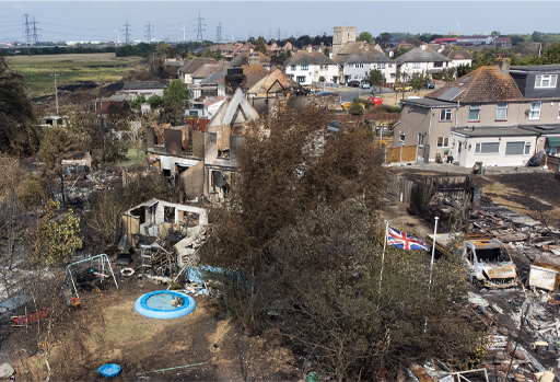 A photograph showing an aerial view of a destroyed residential area, following a fire.