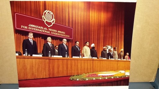 A photo of several world leaders standing behind a desk.