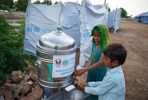 A photograph of children washing their hands