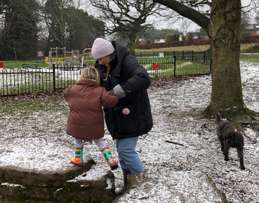 A photograph of a child and adult exploring outside