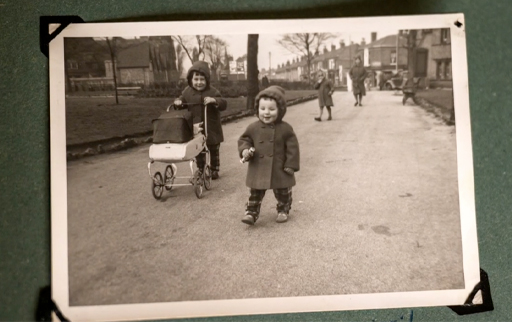 A black-and-white photograph of two young children