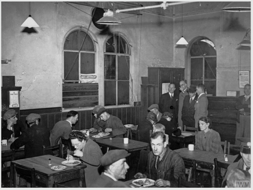 A black-and-white photograph of people eating in a restaurant