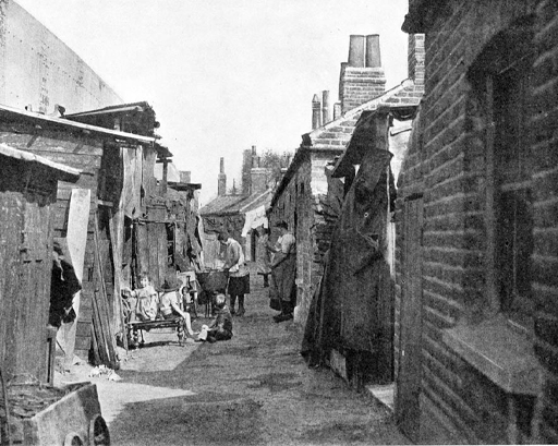 A black-and-white photograph of a street in early twentieth century Britain
