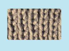 Image of a close-up of a knitted scarf showing the single rib stitch