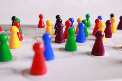 Different coloured pin markers laid out on a board. They appear connected by lines.