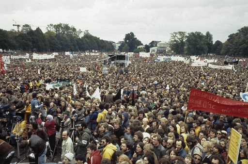 A photograph of a ,large group of people at a demonstration.