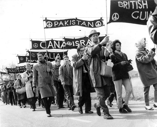 A black-and-white photograph of a protest march.