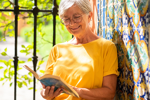 A person reading a book and smiling.