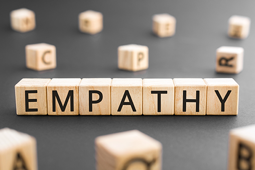 The word ‘Empathy’ spelled out with letters on wooden blocks.